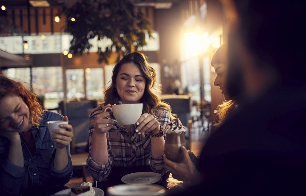 Group of people enjoying coffee together in a cozy café.